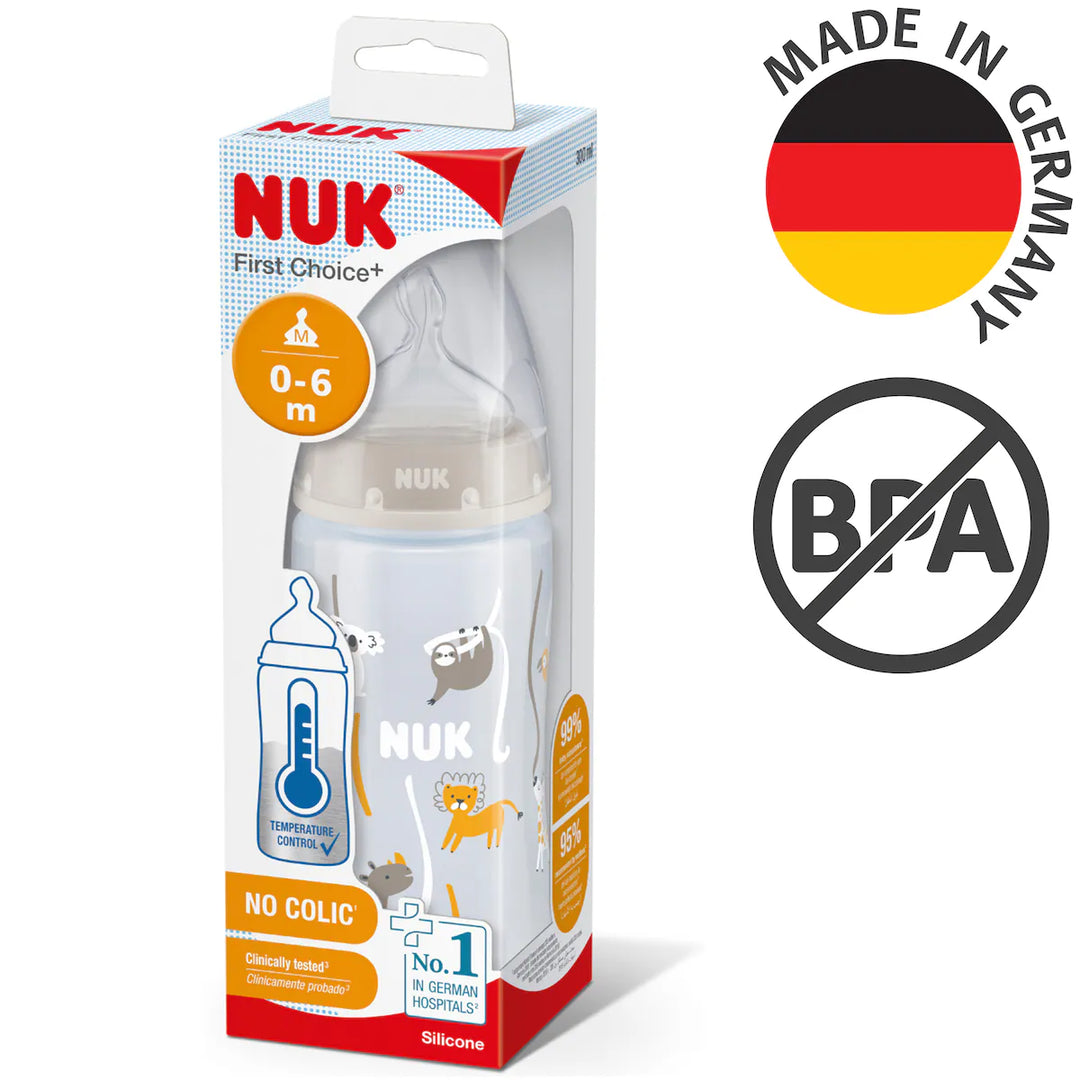 NUK First Choice+ baby bottle with temperature control, packaging, and a bottle teat. The packaging is predominantly white with red and grey accents, and a 'Made in Germany' label, indicating it is manufactured in Germany.