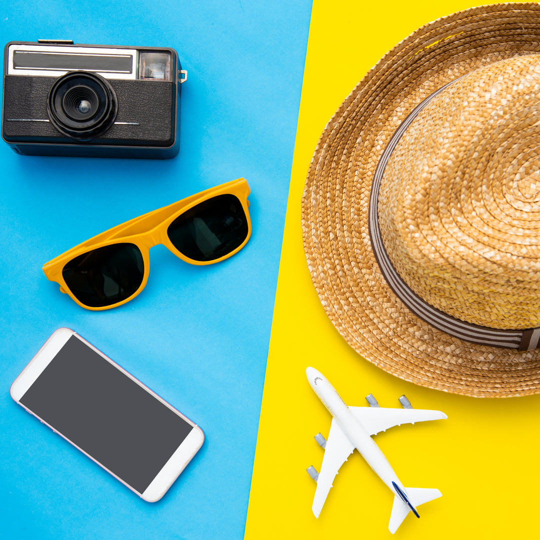 The flat lay image of travel essentials on a colorful background perfectly captures the essence of planning a vacation or summer adventure.