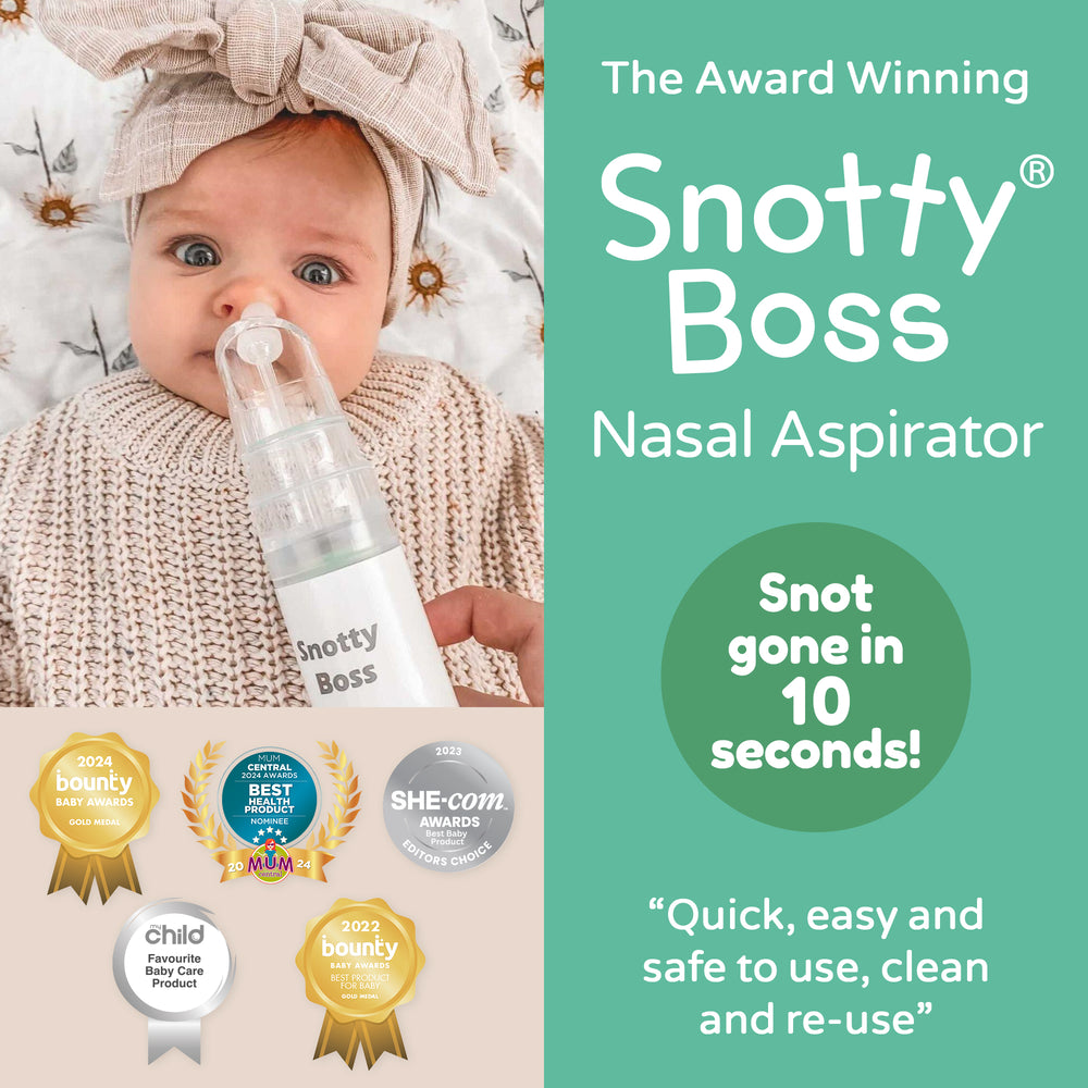 Baby with Snotty Boss nasal aspirator and product packaging with awards on a light background
