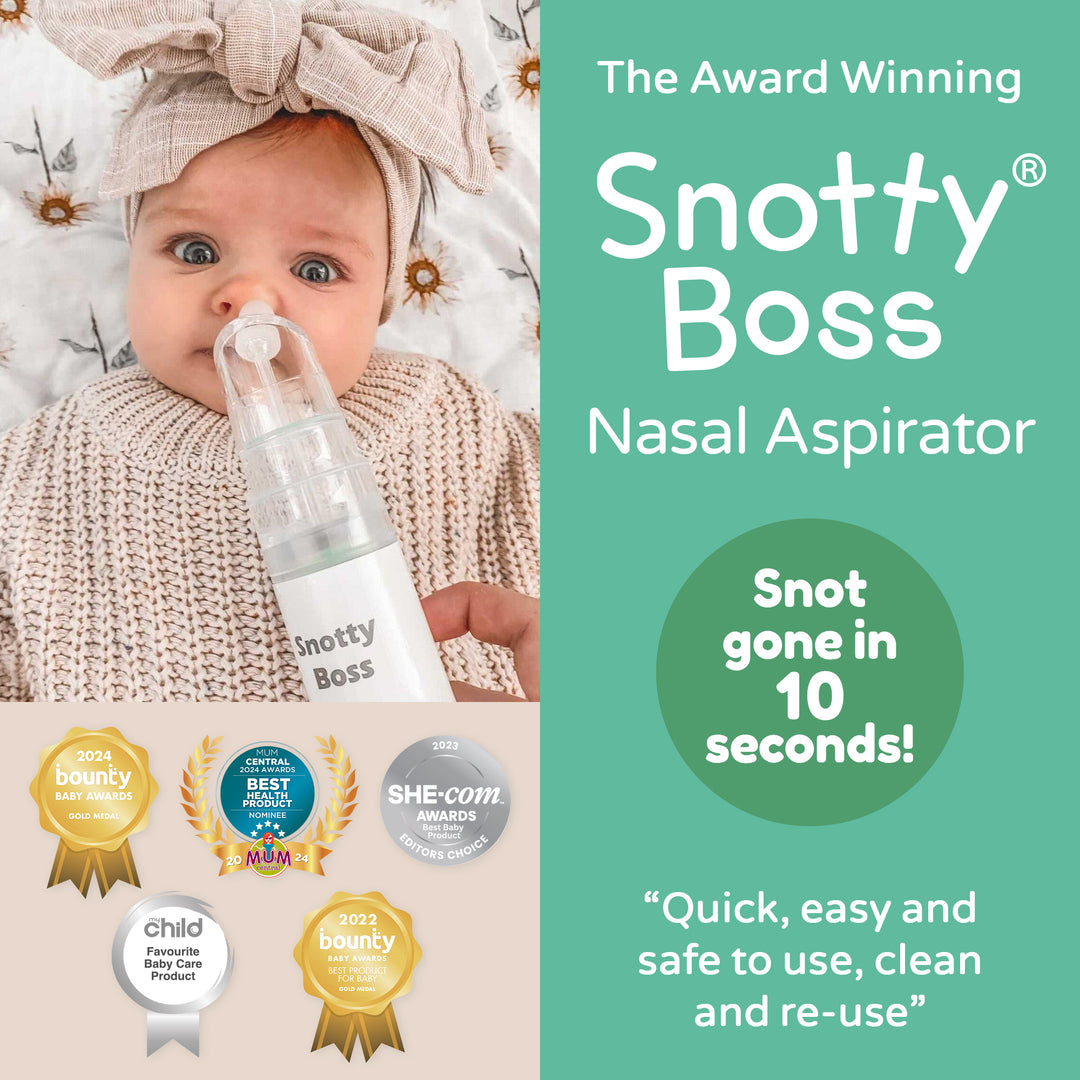 Baby with Snotty Boss nasal aspirator and product packaging with awards on a light background
