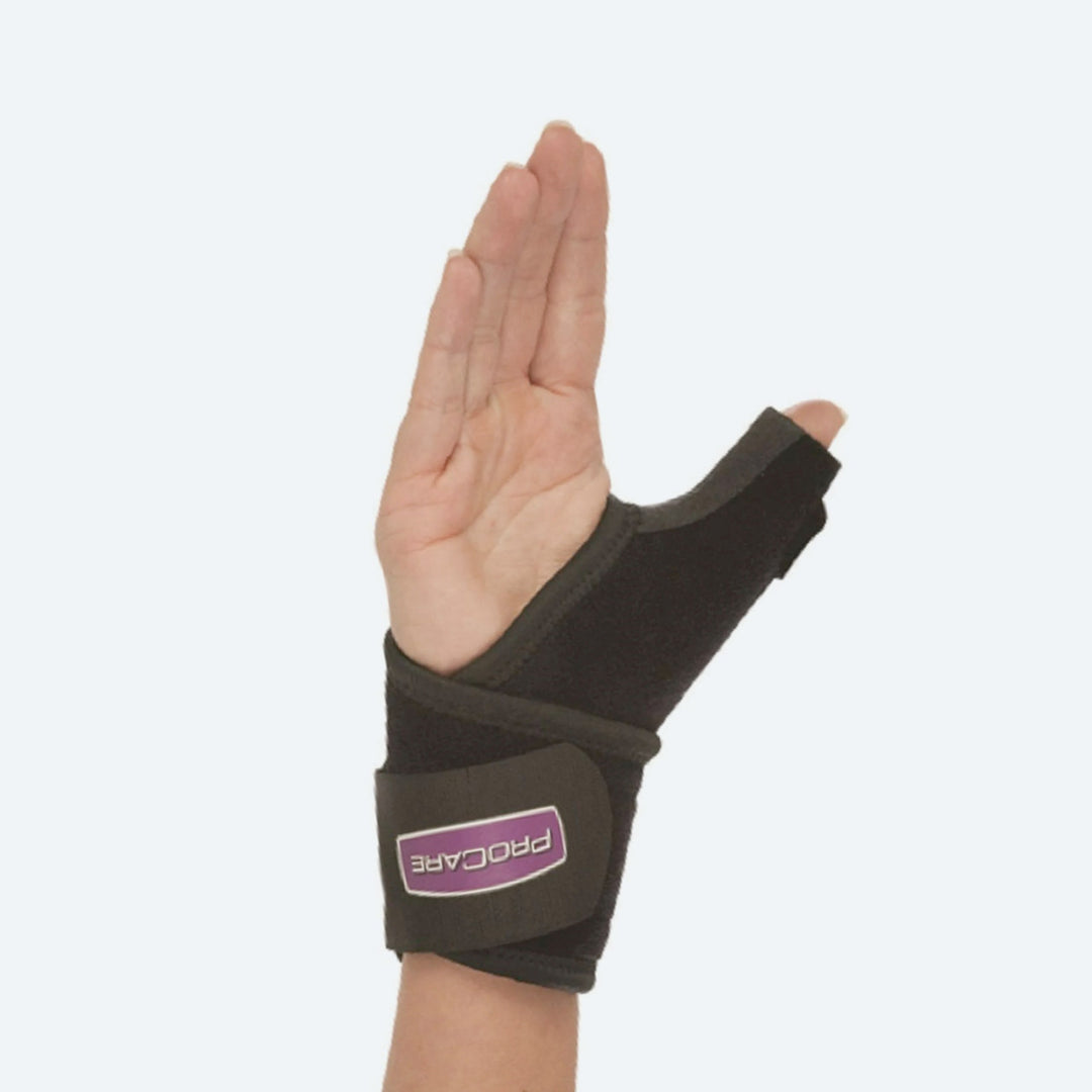 Hand wearing a black wrist support brace with a visible brand logo on a white background